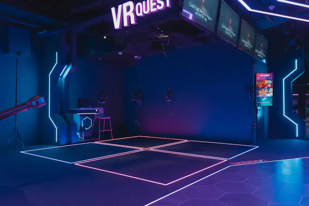 Wide shot of glowing VR play area inside PulseVR Fit